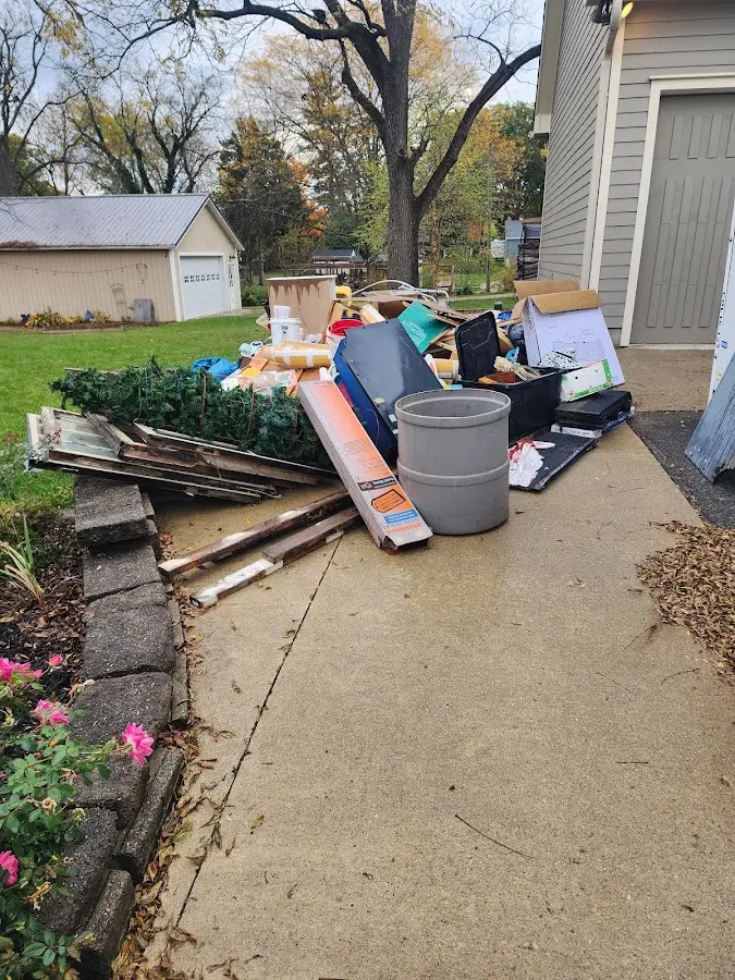 Dumpster being loaded with debris for Estate Cleanout Dumpster Rental in Fortuna Foothills